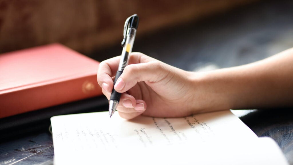 Person writing in journal