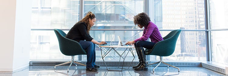 Two people sitting at a table creating the best mission statement