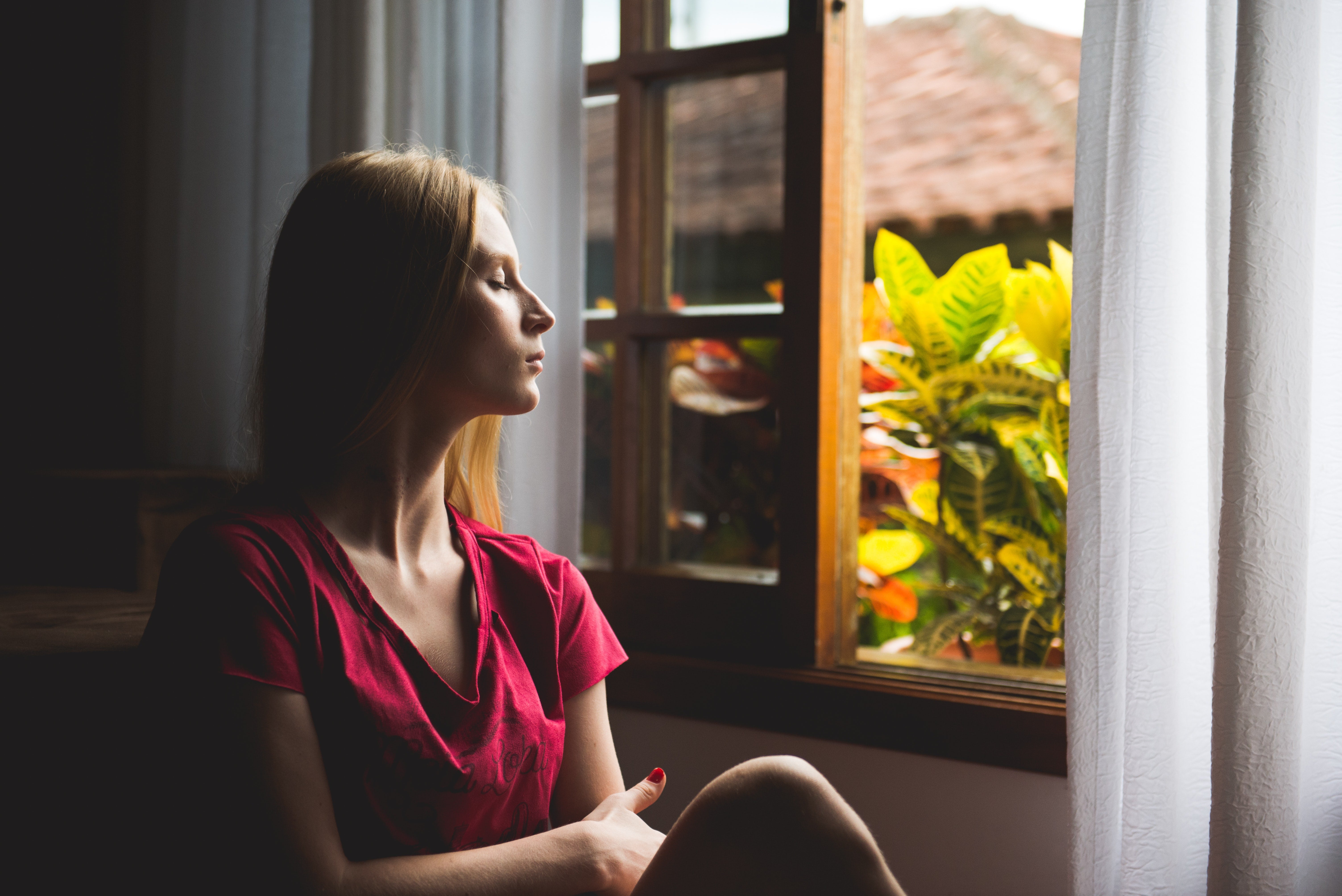 a person in mid-thought at a window
