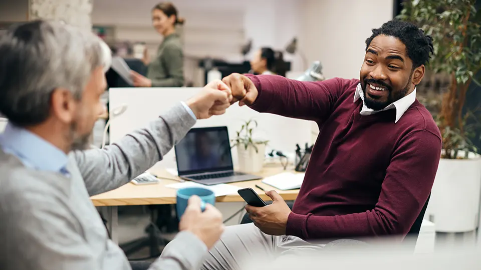 two-male-office-colleagues-fistbump